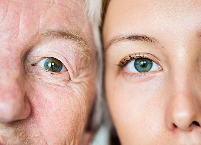 Family generation green eyes genetics concept, older mother and daughter side by side