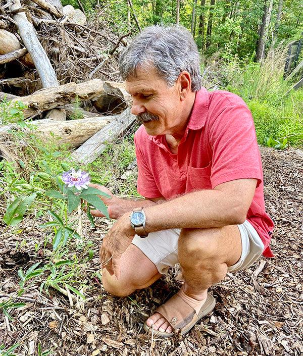 Bill Rawls, MD holding passionflower in the wild