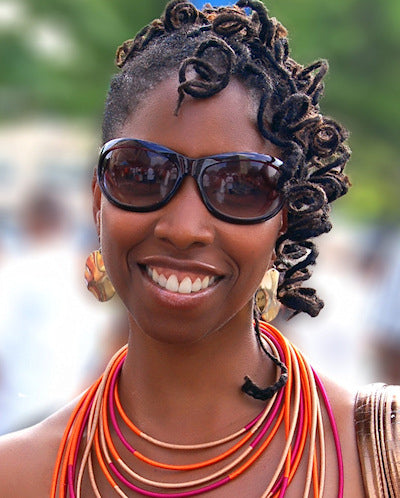 Malene Barnett, awardwinning designer with long curled dreadlocks