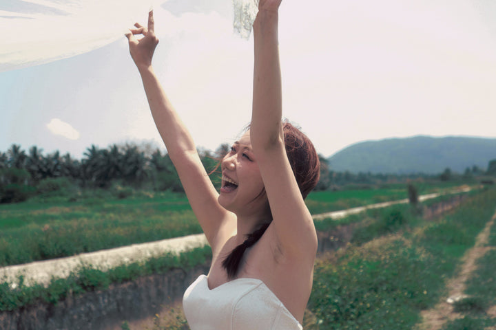 Happy Bride in Field with Natural Bridal Makeup