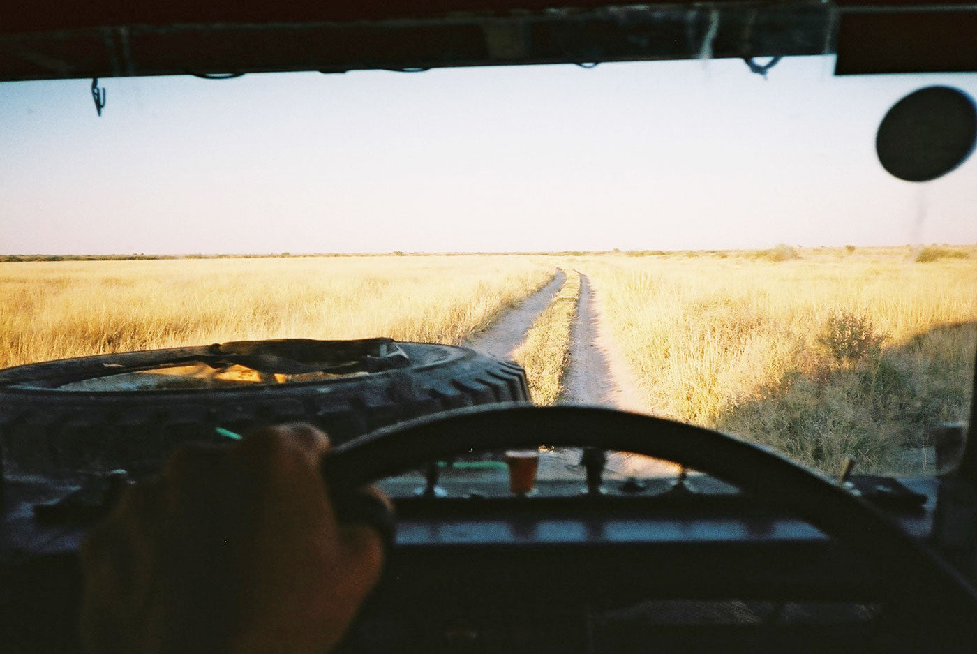 View from the steering wheel outside. Empty rough road in Botswana. (Photo: Lille-Gramberg-Danielsen & Lukas Beuster)