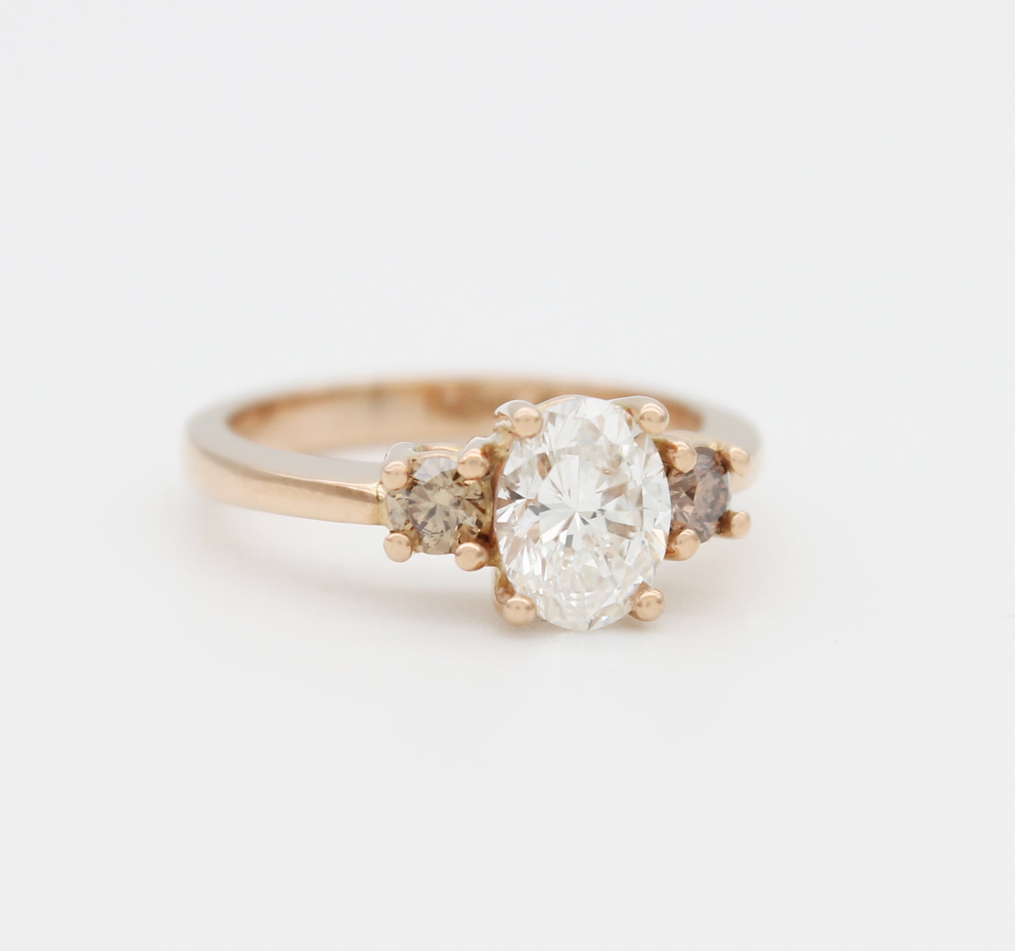 Oval diamond cognac champagne rose gold trilogy ring