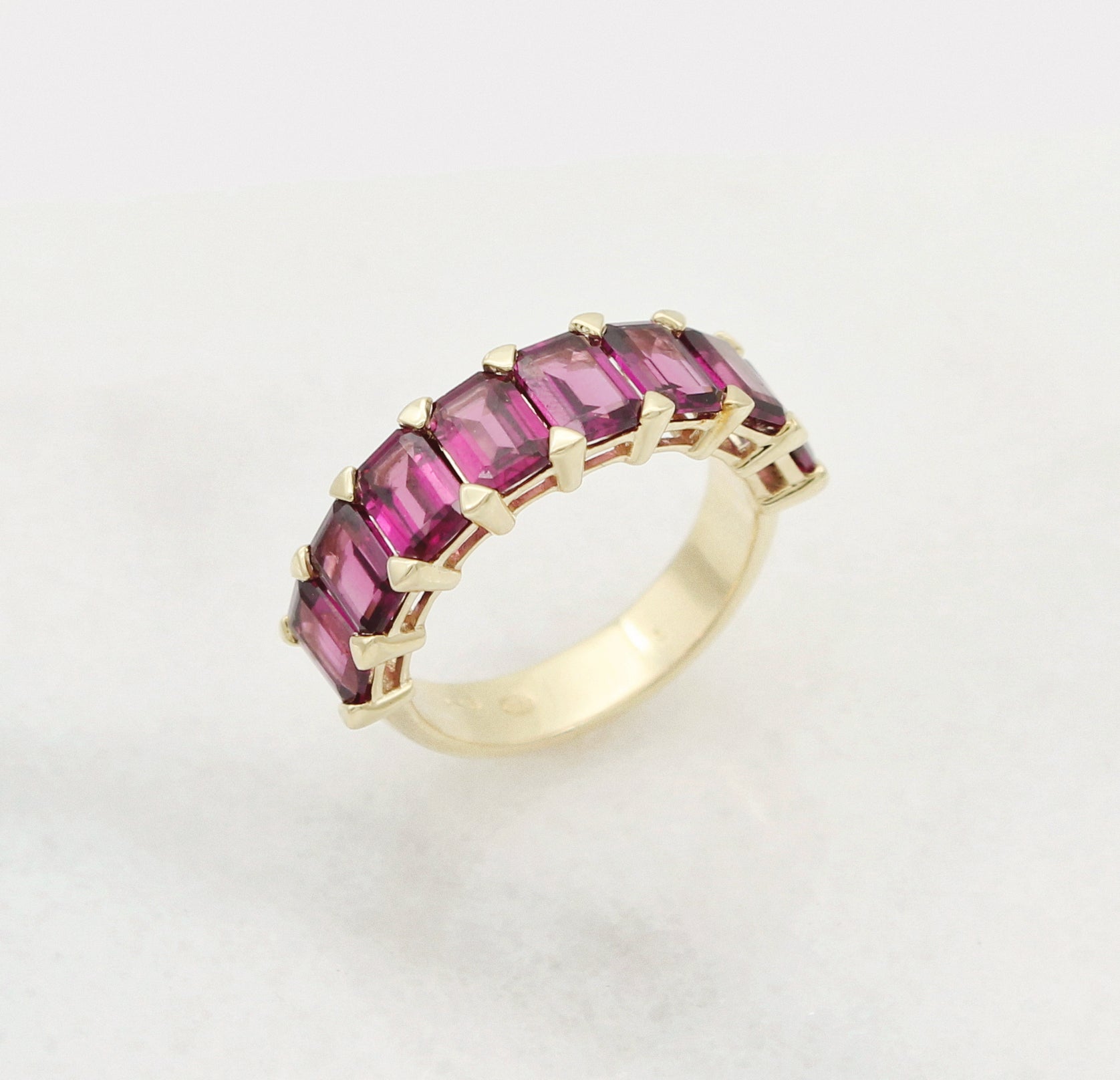 Garnet gemstones set in a custom gold wedding band.