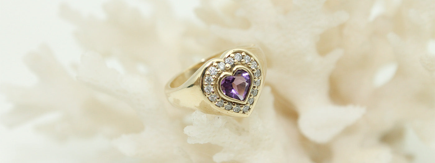 Anna's custom signet ring for her first child, Archie. A heart-shaped custom gold signet ring with Amethyst and white diamonds.