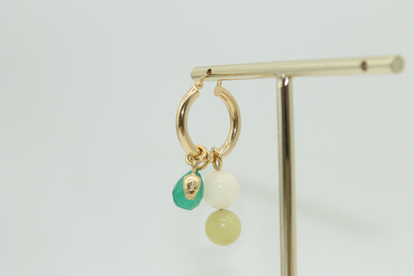 Colourful earring charms on Anna Rosholt's Mama Hoops earrings.