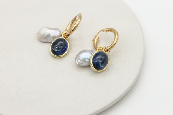 Sapphire set in 9ct gold hoop charms on gold hoop earrings with wonky pearl hoop charms.