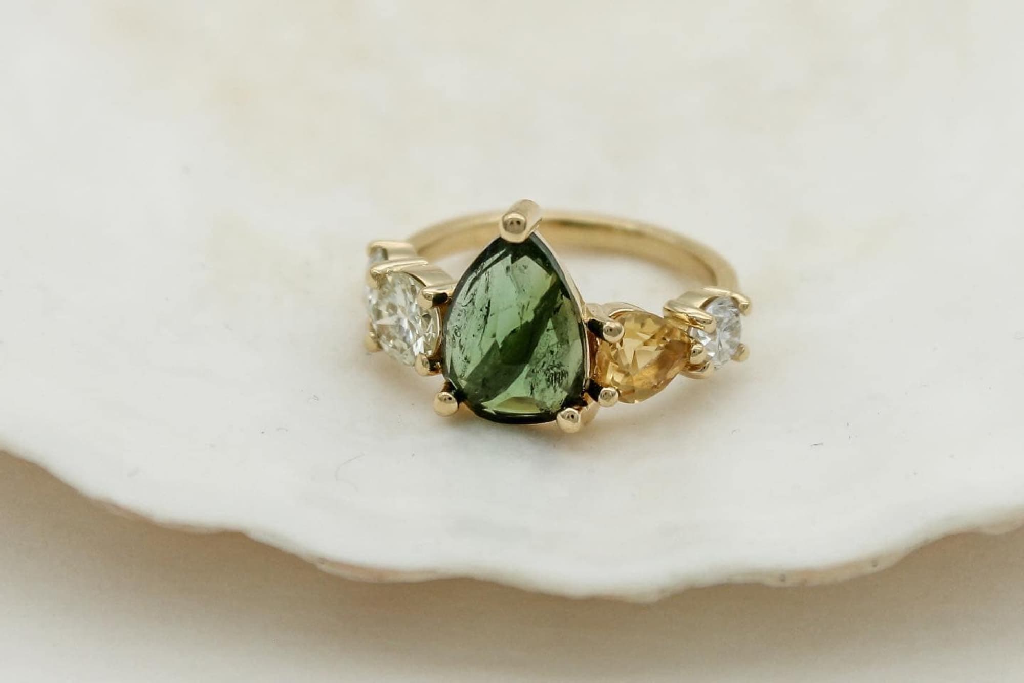 Green Tourmaline Gemstone ring set on 9ct gold band amongst diamonds.