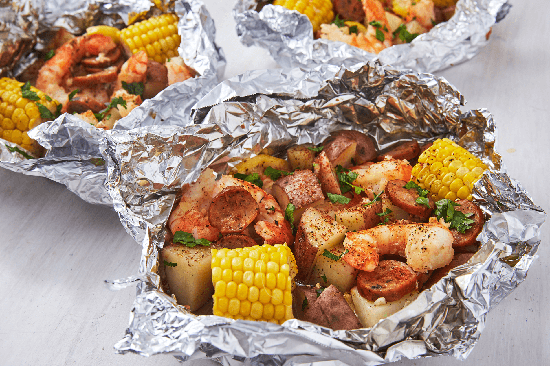 grilled shrimp, corn and vegetables in foil