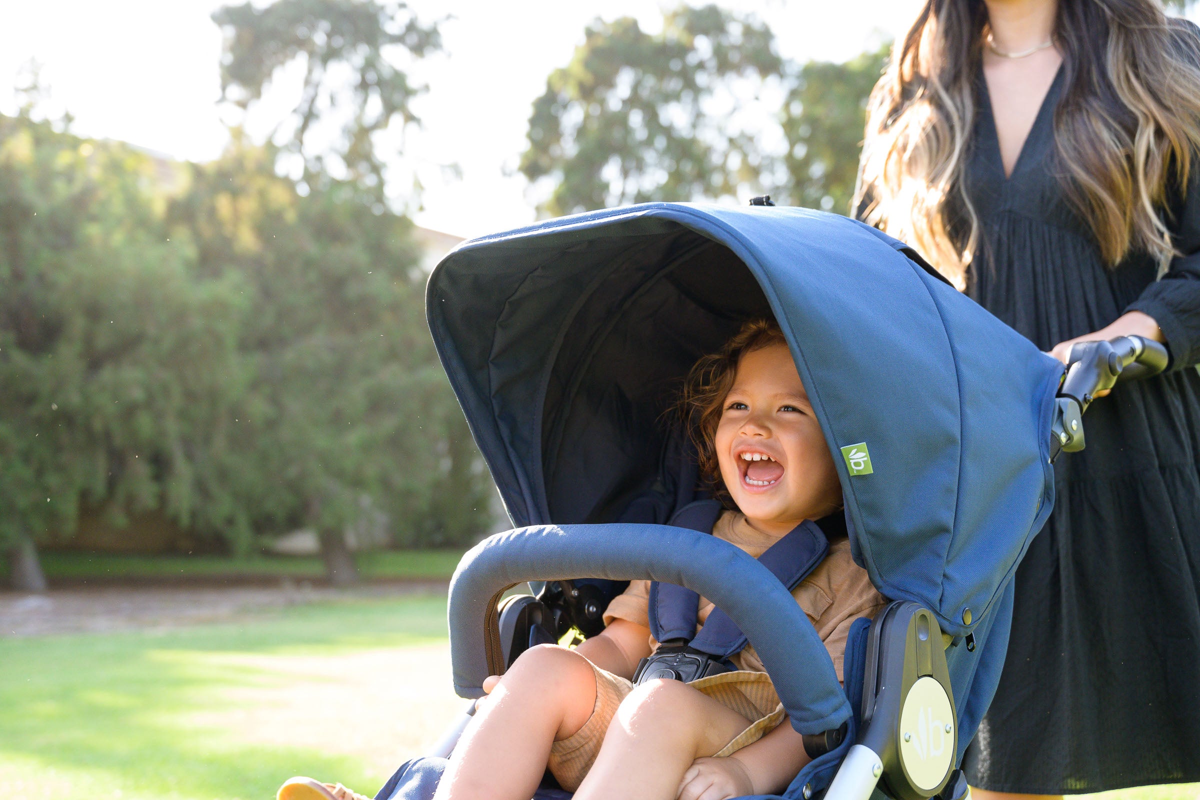 Child smiling inside Maritime Blue Indie all terrain stroller