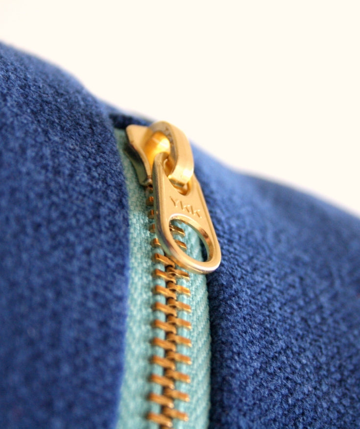 A YKK zipper attached to a pair of denim jeans