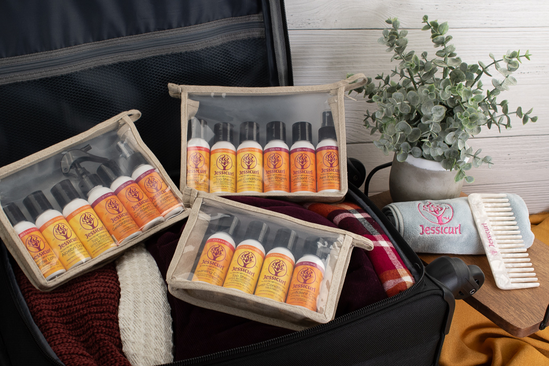 three different collections of product in clear travel bags in a suitcase on a table