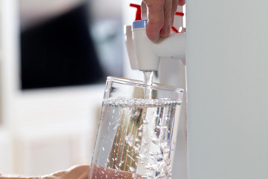 filling glass from water cooler