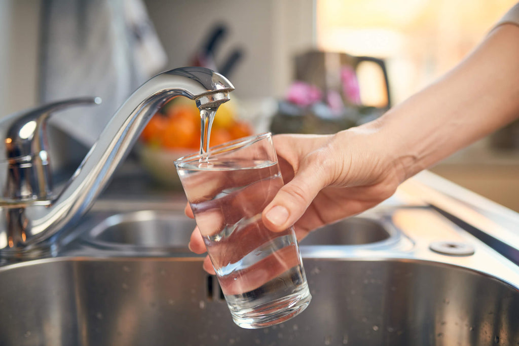 filling glass from faucet