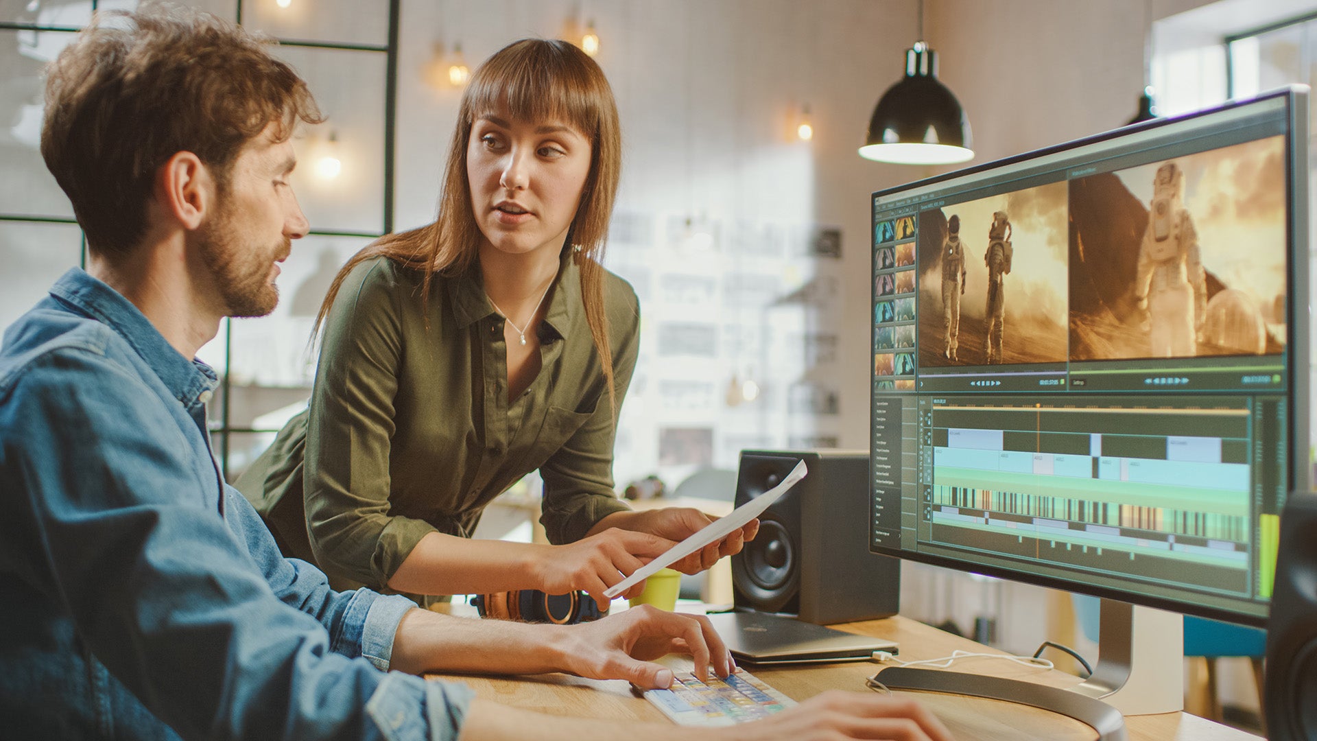 Two people discussing in an editing suite