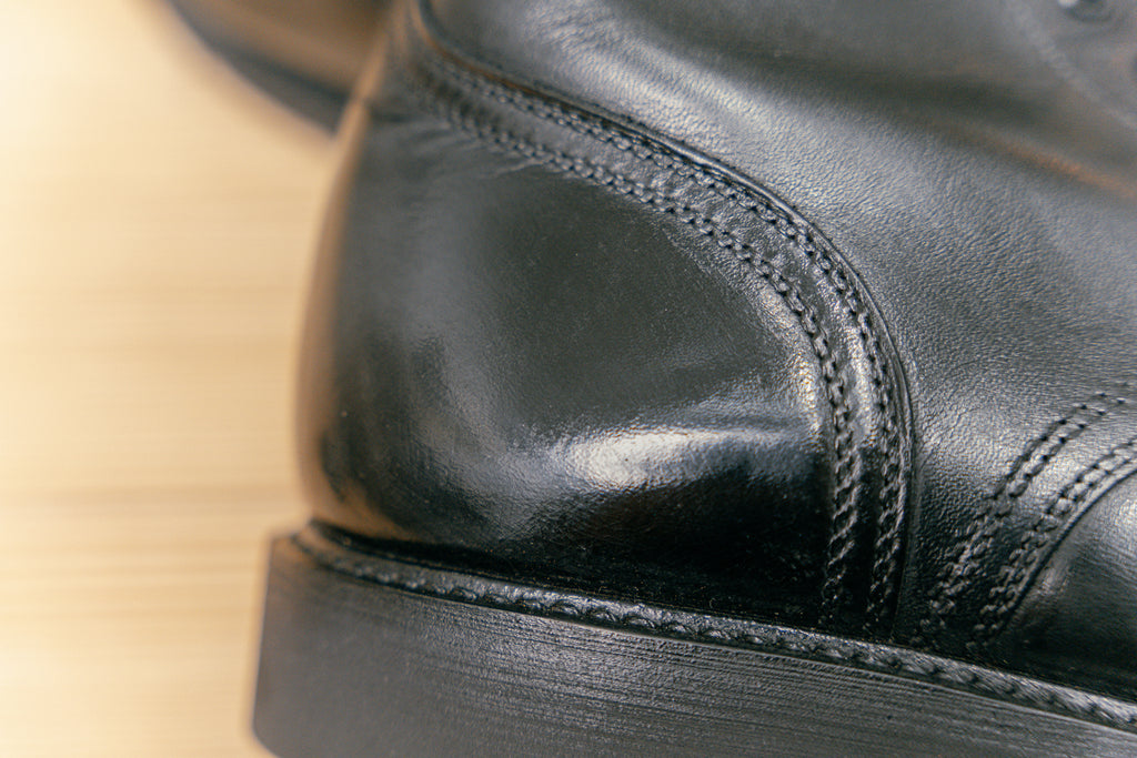 Up close photo of mirror shine heel on pair of military cadet boots that had a parade shine 