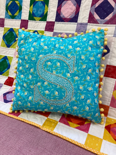 Applique and embellished cushion