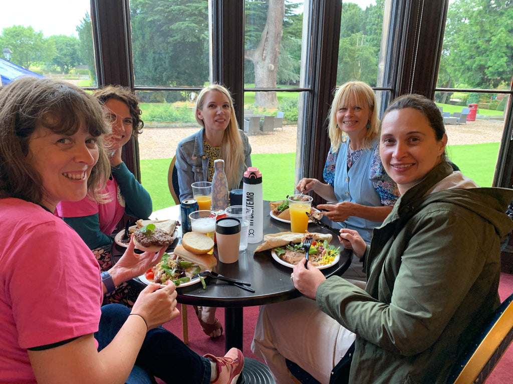 women sitting at a table eating together 