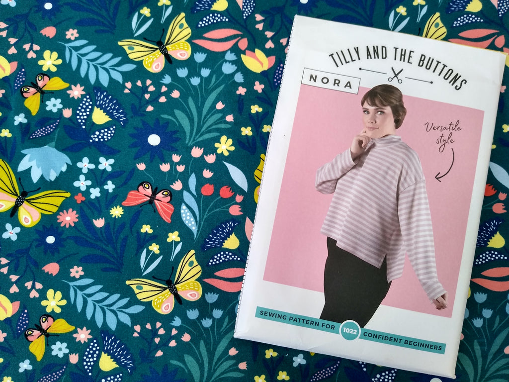 A picture of the Nora sweatshirt dressmaking pattern by Tilly and the Buttons and the jersey fabric used in the blog post
