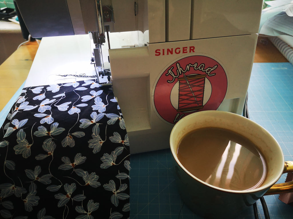 Blue floral viscose fabric and a cup of tea