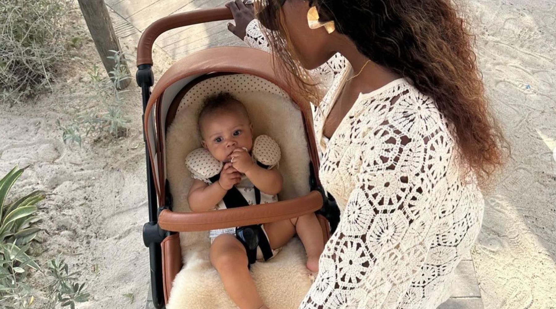 Tropical beach with pram lined with sheepskin, keeping baby cool