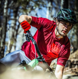 Male cyclist shredding in Syrah coloured Troy Lee Designs Skyline Air Short Sleeve Jersey