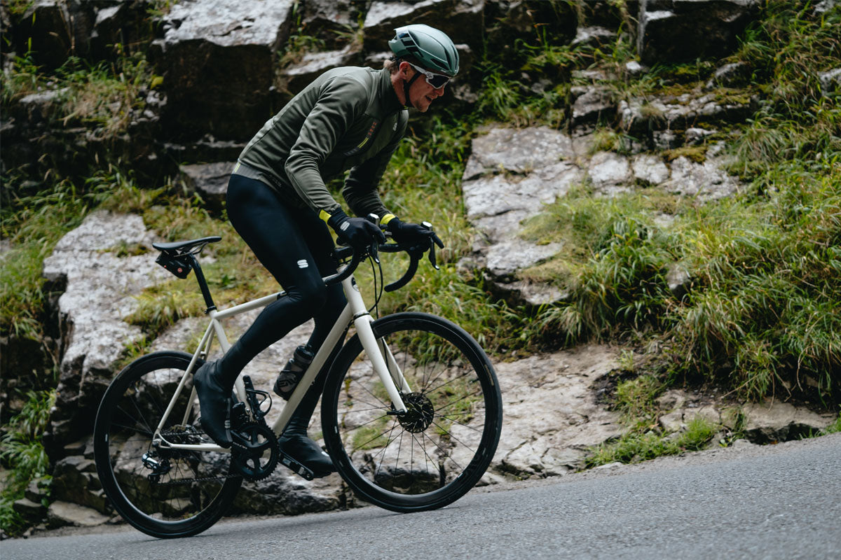 Cyclist riding bike in Sportful bib tights