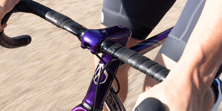 View from in front and above of the ENVE SES AR Handlebar fixed to a purple bike being held up by cyclist