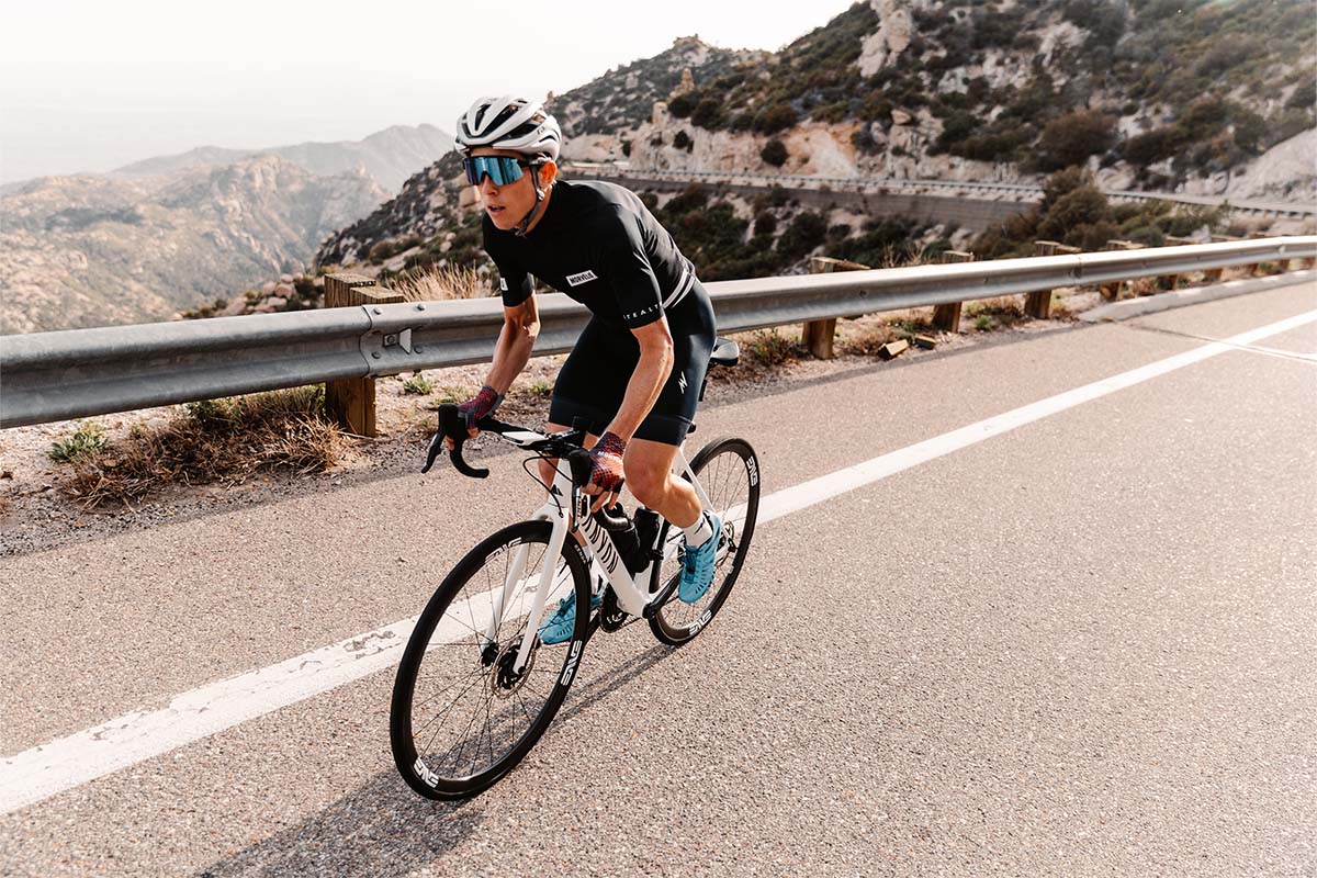 Laughing male cyclist unbuckling TLD A2 helmet