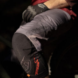 Closeup shot of cyclist's lower half posing in granite coloured Troy Lee Designs Ruckus Shorts