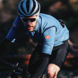 Female cyclist riding in blue yellow and white Castelli Aero Jersey