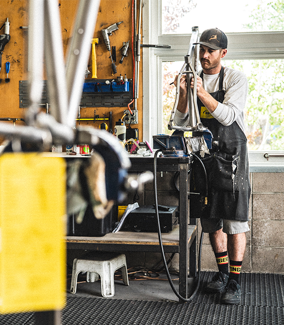 A man in Moots' workshop hand building a frame