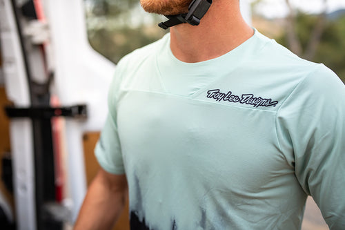 Model wearing the Troy Lee Designs Skyline Jersey in short sleeves. The jersey is a light blue with a darker blue Troy Lee Designs logo