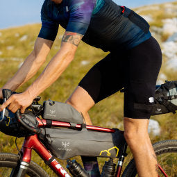Male cyclist perched on bike with hilly backdrop wearing Sportful Ultra Bib Shorts