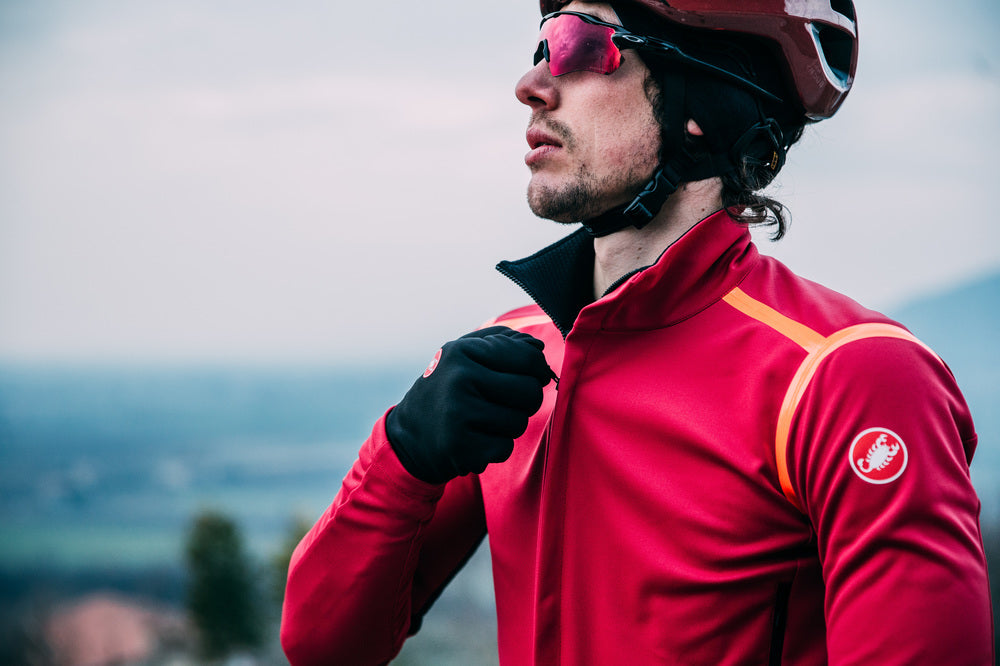 Head and shoulders shot of male cyclist modelling Castelli Perfetto jacket