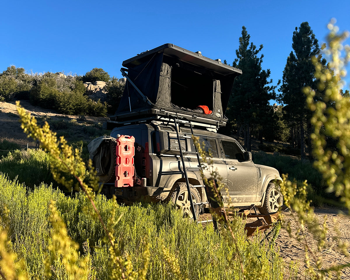 This is a photo of an Evo V2 rooftop tent mounted to a Land Rover Defender