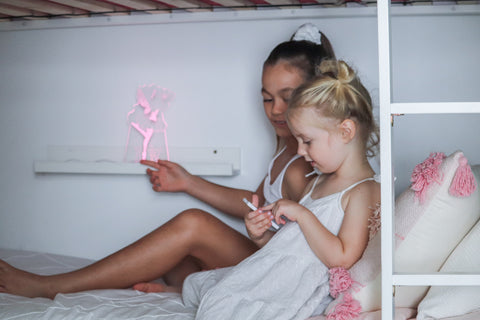 Two girls playing with their sleep fairy night light