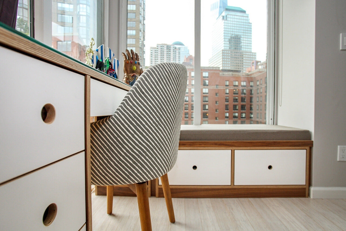 Modern office with striped chair and cityscape.