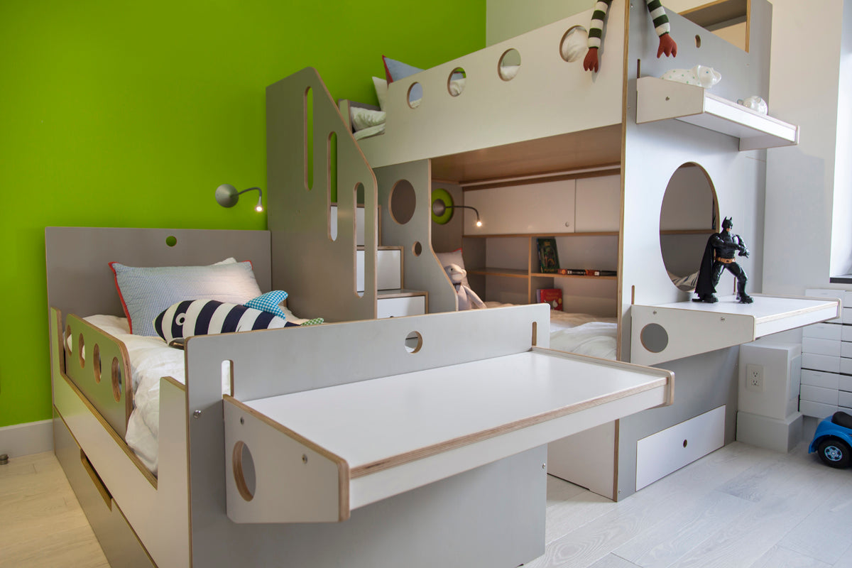 Modern children’s bedroom, green wall, white bunk bed with storage.