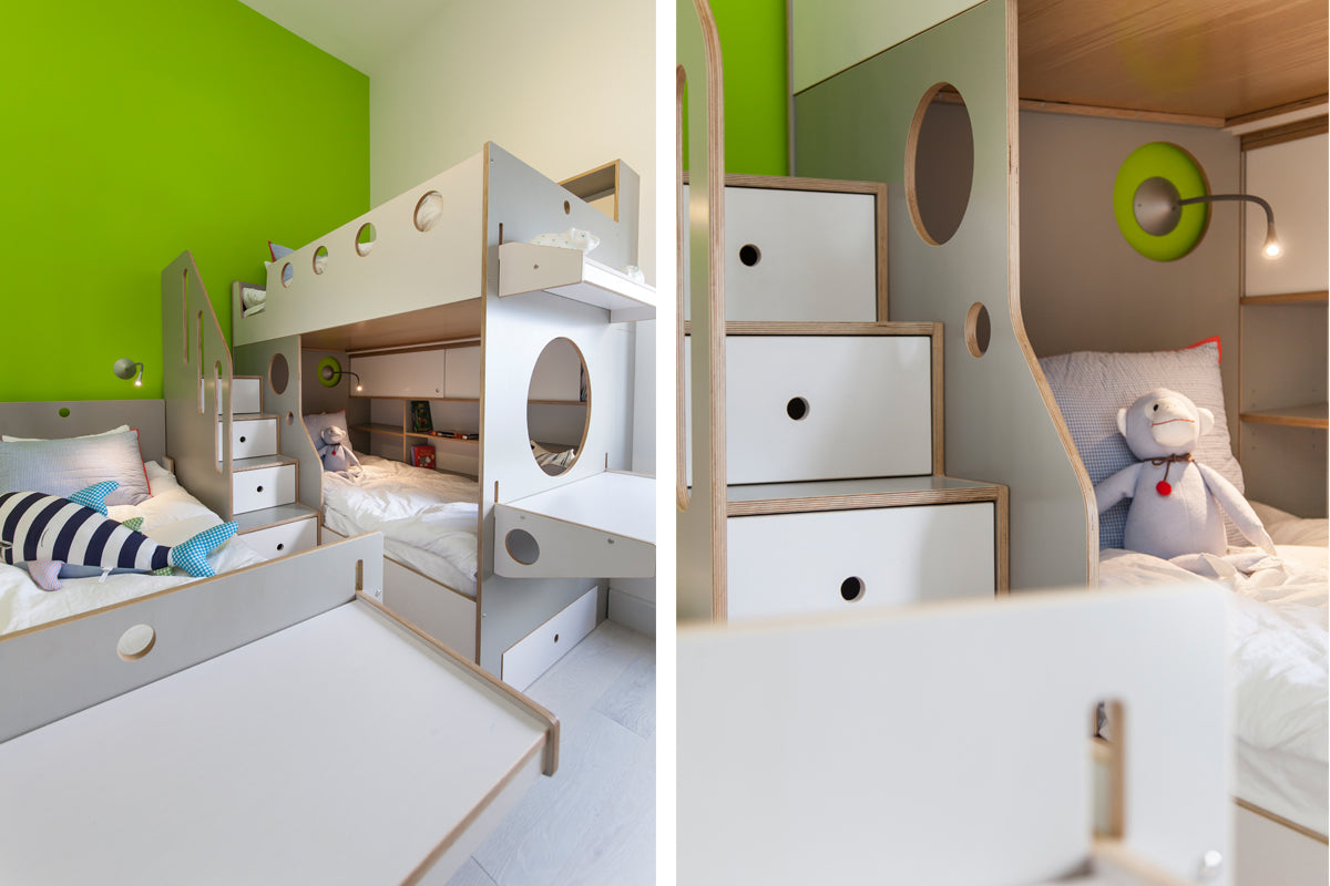 Modern kids’ room with bunk bed, storage drawers, and vibrant green wall.