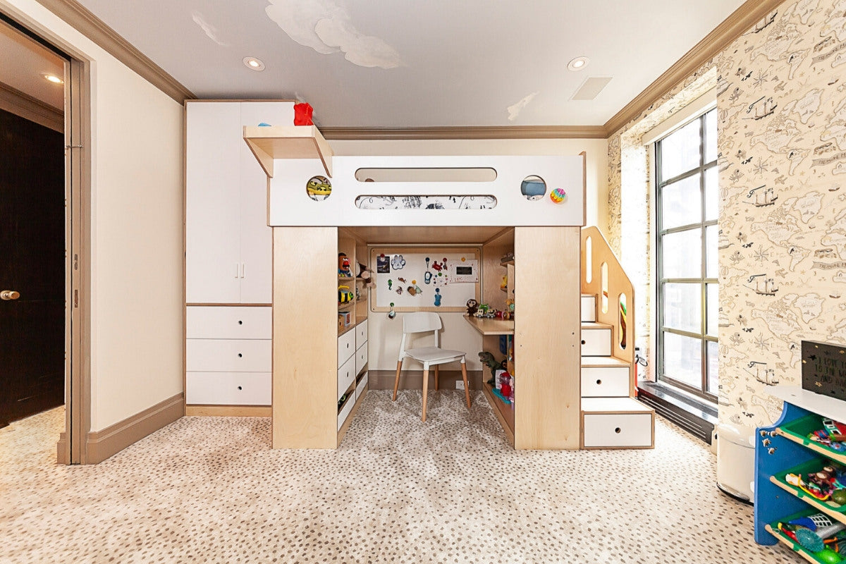 Child's room featuring a loft bed with built-in storage and desk, airplane-patterned wallpaper, and window.