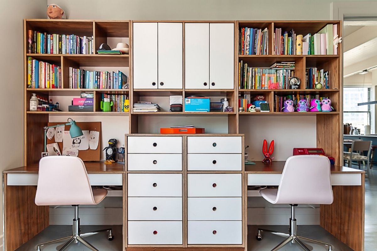 Organized study space with shelving, desk, and chairs.