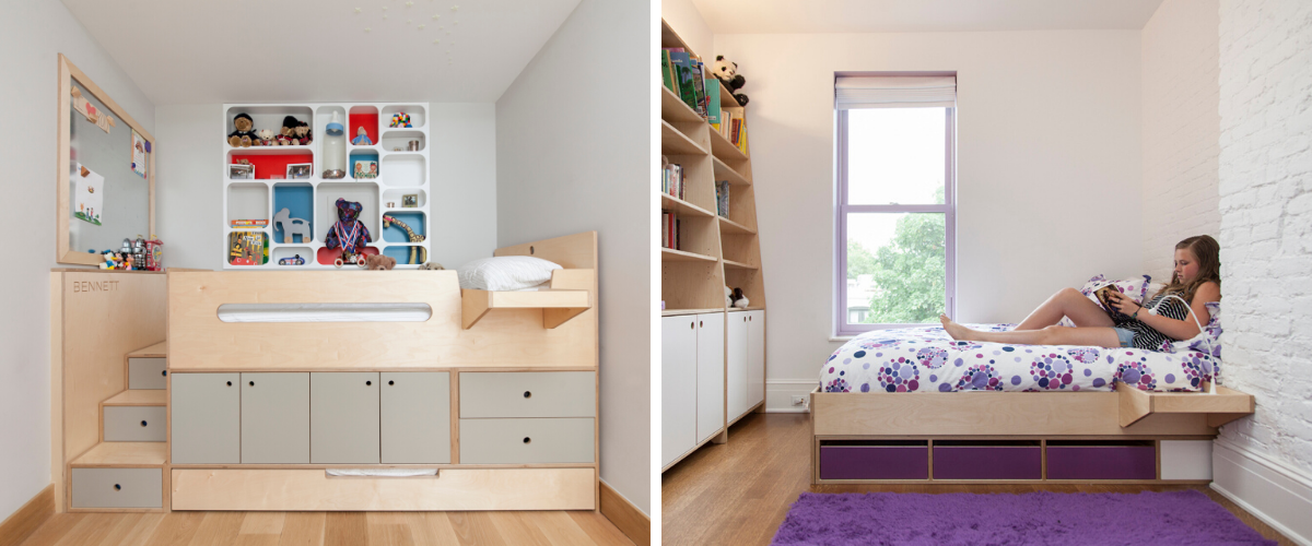 Person reading by window in compact room with desk, shelves, and bed.