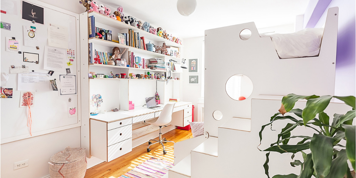 Bright and airy child's room featuring a study area with a desk and shelves, and a loft bed accessible by white stairs.