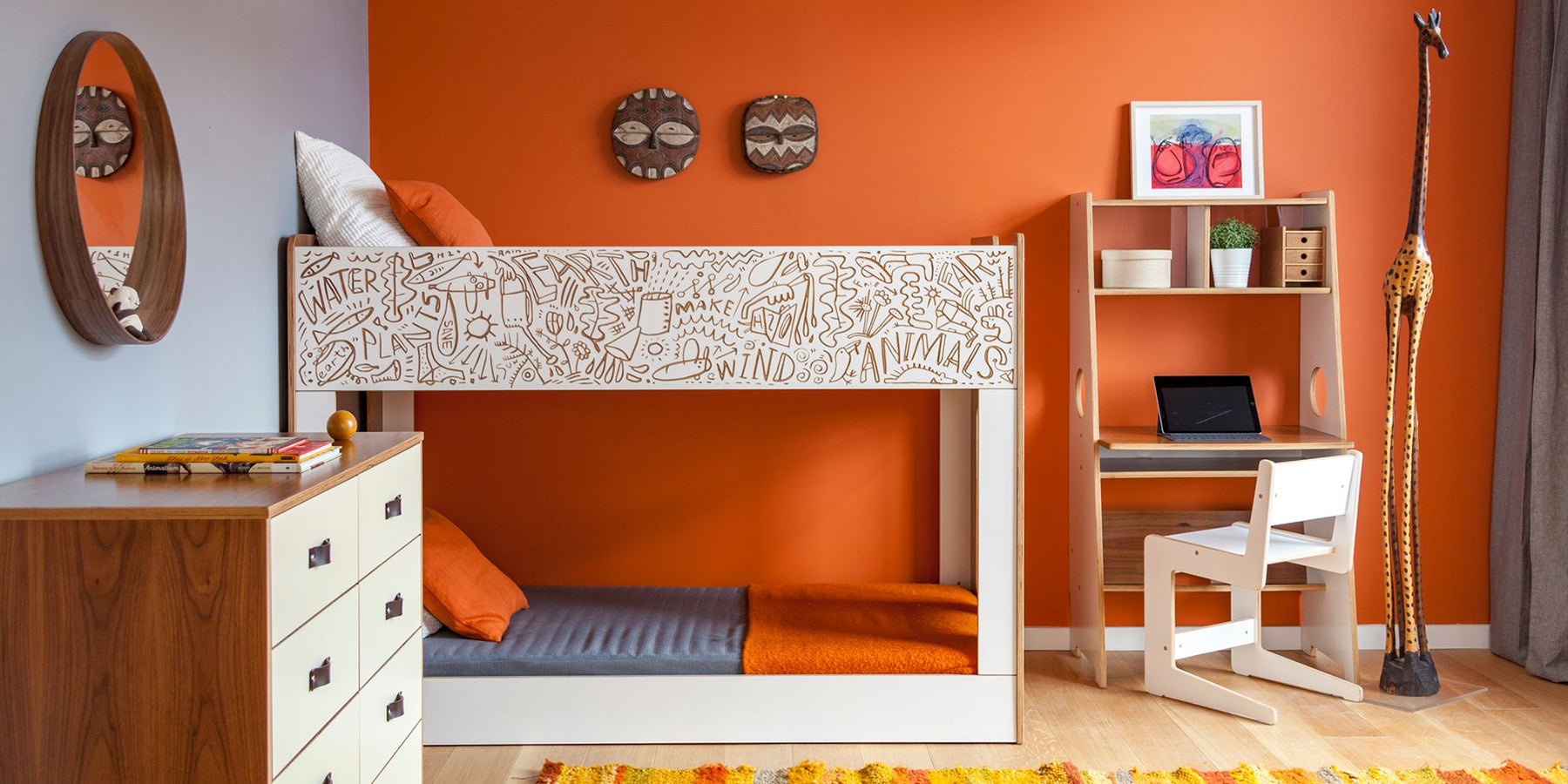 Colorful bedroom with ornate white bunk bed, orange walls, wooden furniture, and musical instruments.