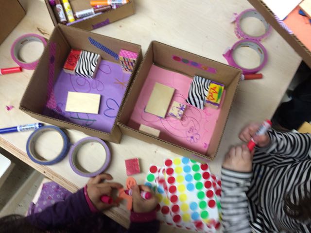 This image shows young children engaged in craft activities using colorful materials.