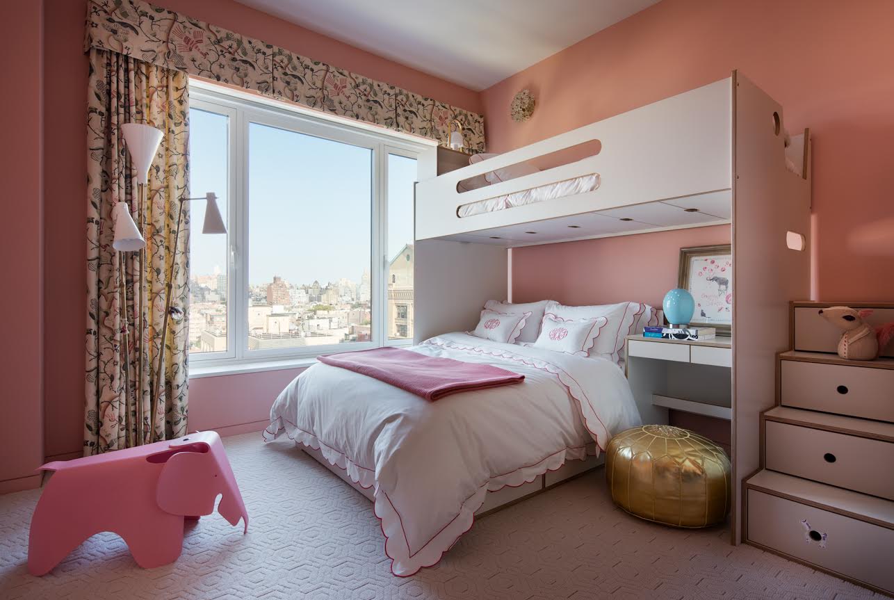 A child's bedroom with a pink loft bed, a desk underneath, plush toys, and a window showing a cityscape.