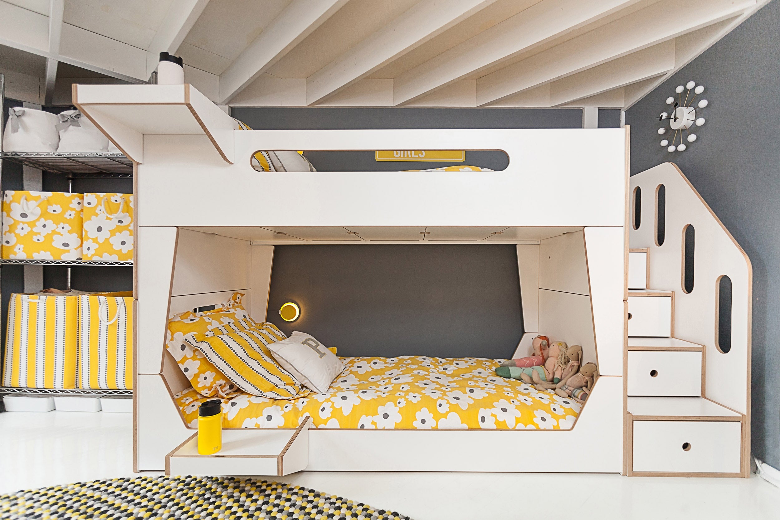 Modern kids’ room with bunk bed, storage, and yellow details.