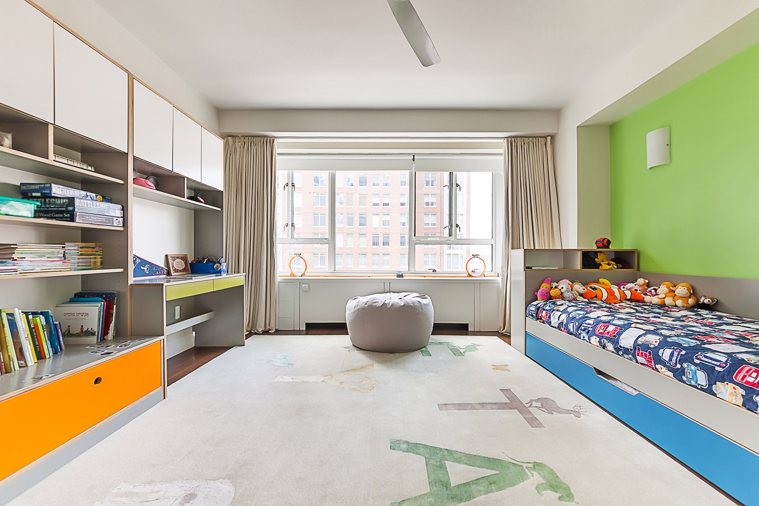 Colorful child’s room with toys and large window.