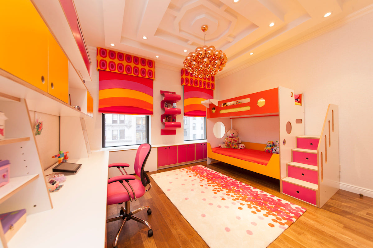 Colorful child’s room with bunk bed, desk, bright decor.