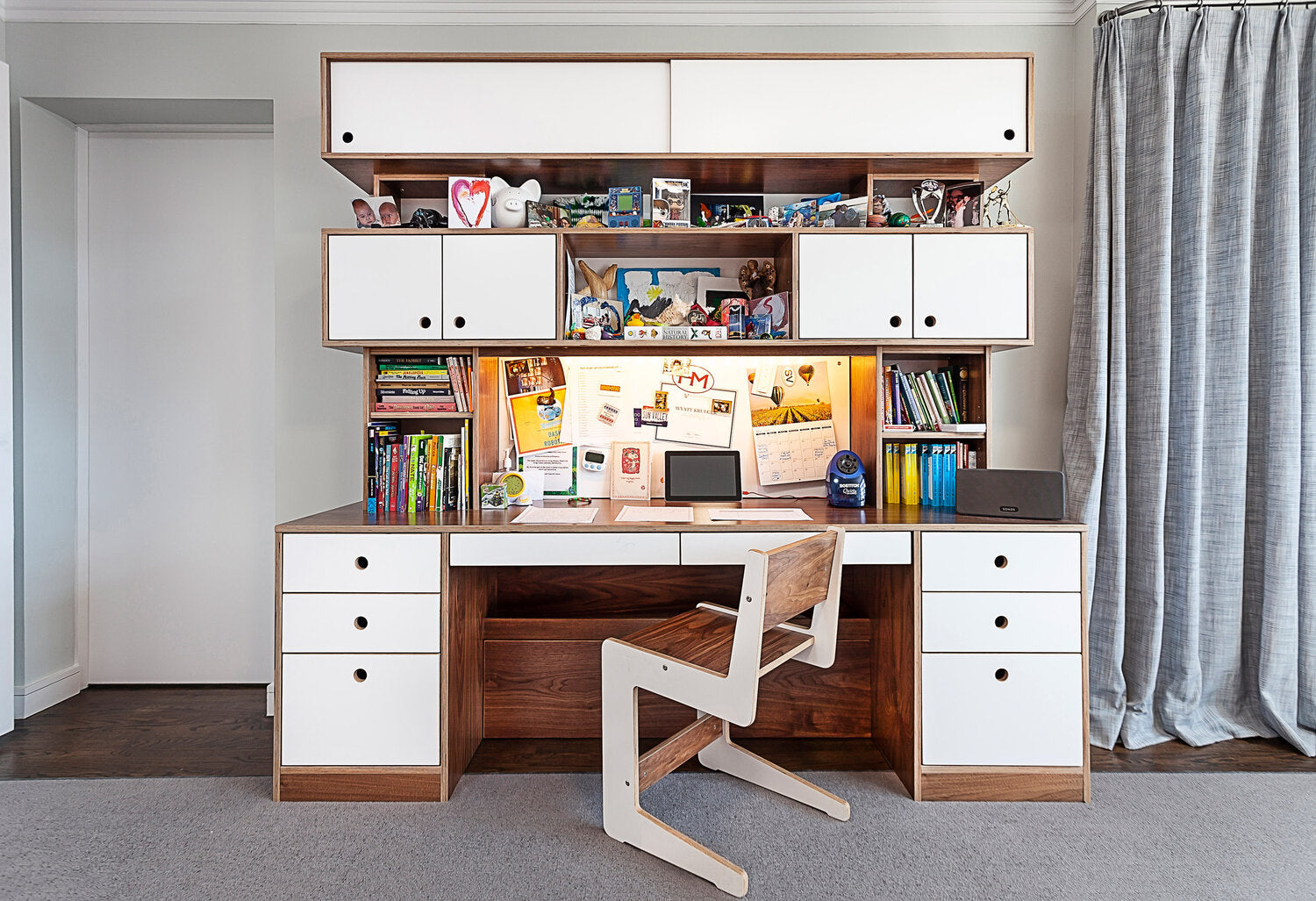 Organized study desk with computer, books, and personal items.